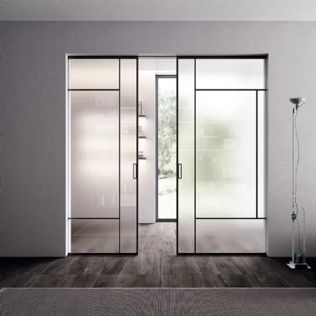 double wave sliding door in clear transparent glass design Bertolotto Internal doors made in Italy